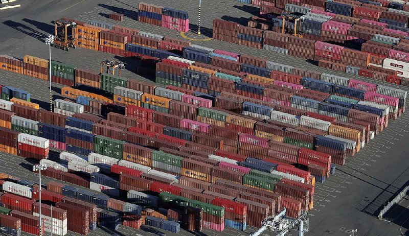 In this March photo, cargo containers are staged near cranes at the Port of Tacoma, in Tacoma, Wash.