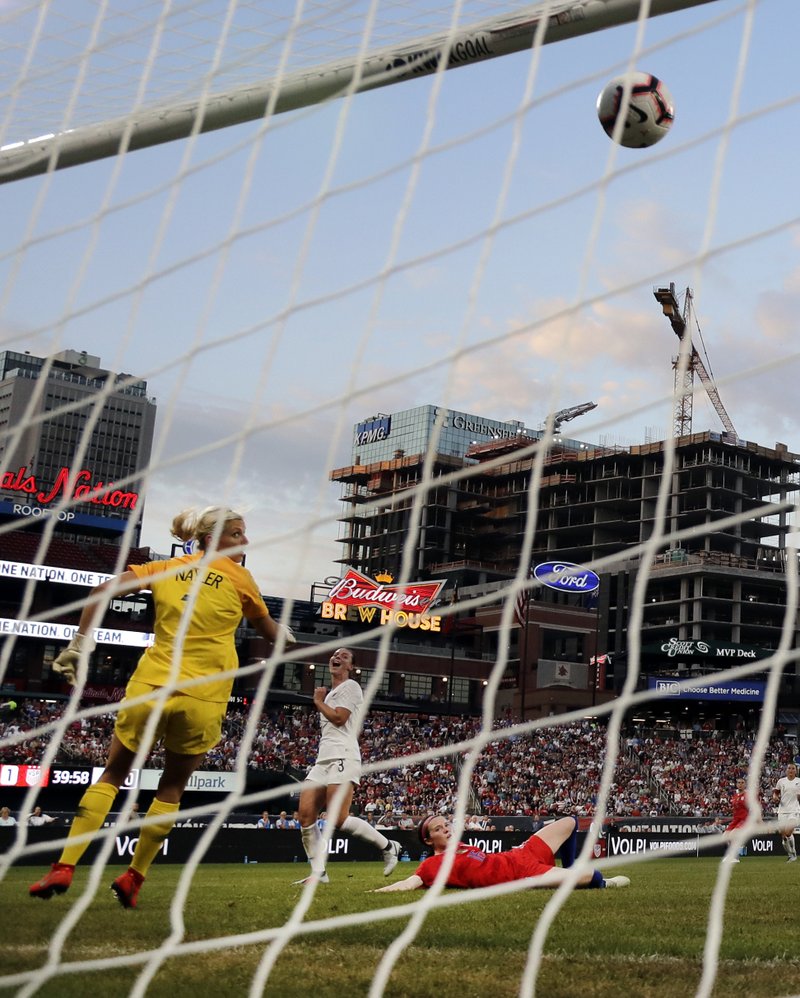 The Associated Press FINDING THE CORNER: United States' Rose Lavelle, bottom right, scores past New Zealand goalkeeper Erin Nayler, left, and Anna Green (3) during the first half of Thursday's international friendly soccer match in St. Louis.