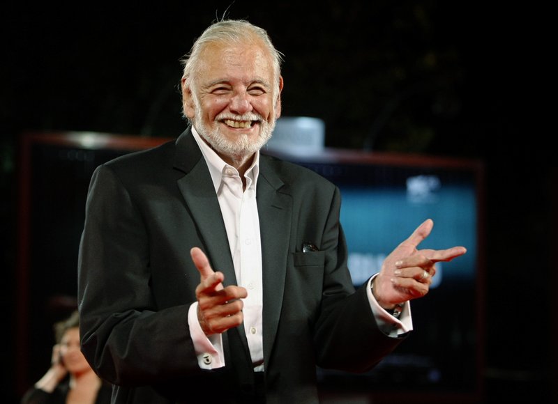 FILE - In this Sept. 9, 2009, file photo, director George Romero arrives for the screening of the film &quot;Survival Of The Dead&quot; at the 66th edition of the Venice Film Festival in Venice, Italy. The University of Pittsburgh is getting a spooky addition: the archives of late iconic filmmaker George A. Romero. His horror flicks date back to the 1968 film &#x201c;Night of the Living Dead,&#x201d; and many consider him the godfather of zombie cinema. The archives will be available to scholars, students and filmmakers and include the original annotated &#x201c;Night of the Living Dead&#x201d; script and a foam latex zombie head. (AP Photo/Andrew Medichini, File)