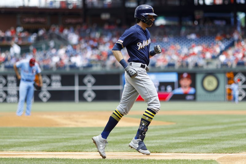 The Associated Press TAKING A TRIP: Milwaukee Brewers' Christian Yelich, right, rounds the bases after hitting a home run off Philadelphia Phillies starting pitcher Zach Eflin, left, during the first inning of Thursday's game in Philadelphia.