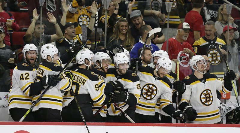 The Associated Press BRUIN SWEEP: Boston Bruins players celebrate during the closing moments of the team's NHL Stanley Cup Eastern Conference final Thursday against the Carolina Hurricanes in Raleigh, N.C. Boston won, 4-0, to advance to the Stanley Cup Final.