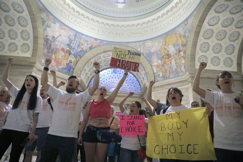 Abortion-rights activists react after lawmakers approved a sweeping piece of anti-abortion legislation, a bill that would ban most abortions in the state of Missouri, Friday, May 17, 2019 in Jefferson, Mo. If enacted, the ban would be among the most restrictive in the U.S. It includes exceptions for medical emergencies, but not for pregnancies caused by rape or incest. Doctors would face five to 15 years in prison for violating the eight-week cutoff. Women who receive abortions wouldn't be prosecuted. (Christian Gooden/St. Louis Post-Dispatch via AP)