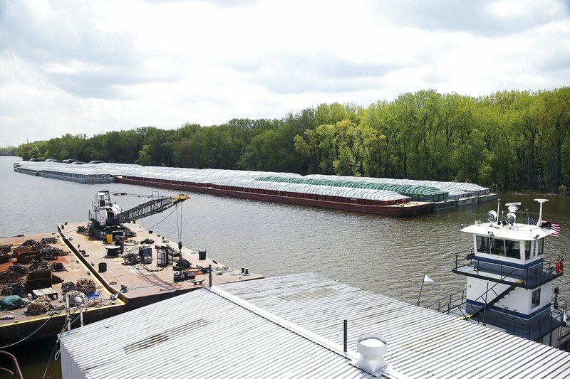 In this Tuesday, May 14, 2019 photo, barges already loaded with soy beans, potash or scrap steel await movement on the Mississippi River in St. Paul, Minn., as spring flooding interrupts shipments on the river. Historic Midwest flooding that began in March has left parts of the Mississippi River closed for business.