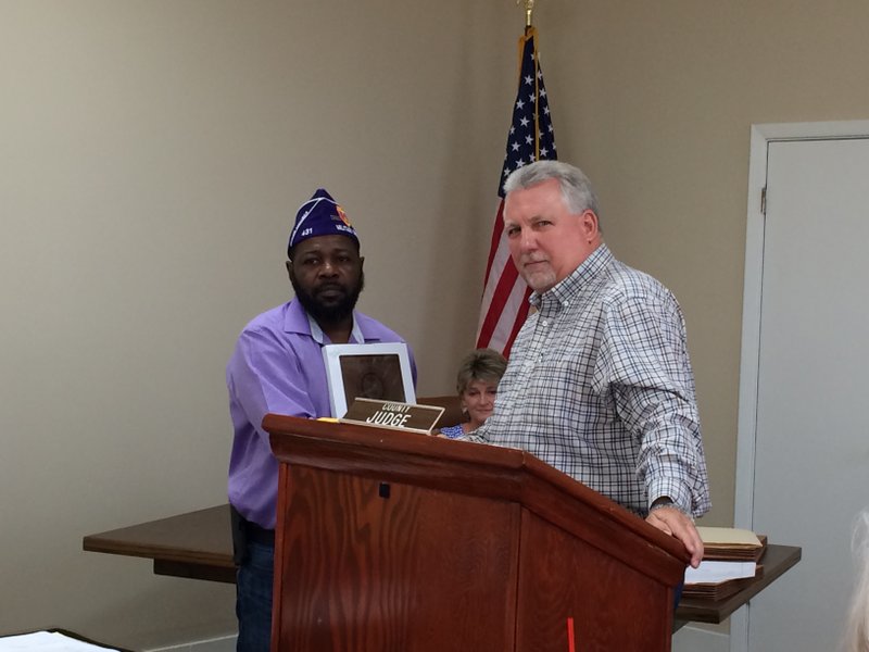 Purple Heart: Purple Heart Commander Jimmy Lewis (left) presents Union County Judge Mike Loftin with a plaque designating Union County as a Purple Heart County.