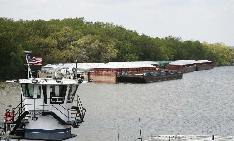 Empty barges sit moored Tuesday on the Mississippi River in St. Paul, Minn., as spring flooding interrupts shipments on the river. 