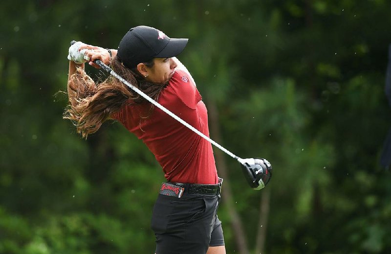 Arkansas’ Maria Fassi watches her tee shot on No. 10 during Saturday’s second-round play at the NCAA women’s championship in Fayetteville. Fassi was 2 under through 11 holes and 3 under overall, one stroke behind Arizona’s Bianca Pagdanganan. 