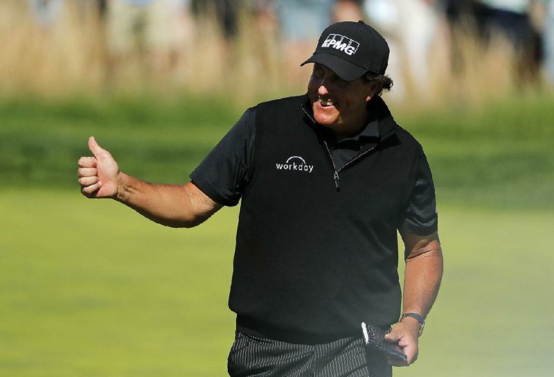 Phil Mickelson gives a thumbs up as he walks along the 17th green Saturday during the third round of the PGA Championship at Bethpage Black in Farmingdale, N.Y. “As the putts go down, the thumbs are coming up,” Mickelson said. 