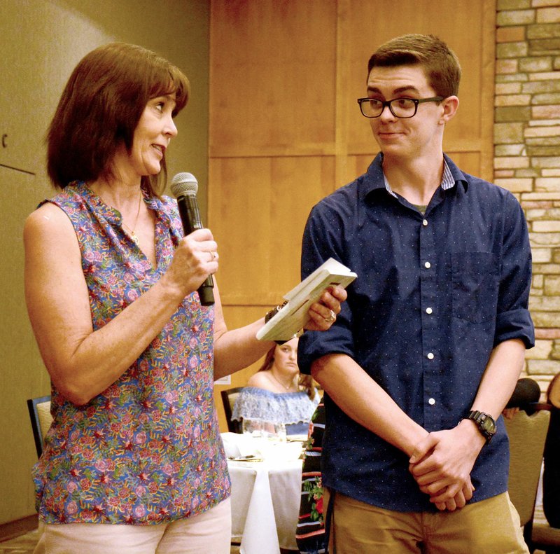 Janelle Jessen/Siloam Sunday Marla Collins, representing Moss Insurance, presented Joshua Cottrell during the 42nd annual Chamber of Commerce Honor Graduate Luncheon on Thursday. Twenty-four honor and high honor students were recognized during the event, which took place at Simmons Great Hall.