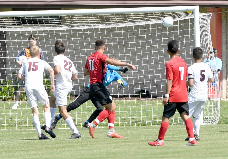 Bud Sullins/Special to Siloam Sunday Russellville's Wesly Robinson, No. 11, shoots past Siloam Springs goalkeeper Wyatt Church for the game's only goal in a 1-0 Cyclones win Friday in the Class 5A Boys Soccer State Championship Game at Razorback Field in Fayetteville.
