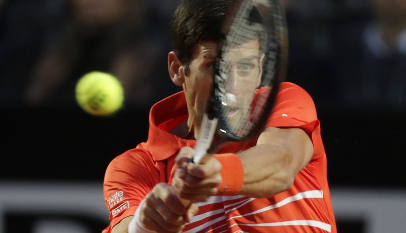 The Associated Press POWER RETURN: Novak Djokovic of Serbia returns the ball to Diego Schwartzman of Argentina Saturday during a semifinal match at the Italian Open tournament in Rome.
