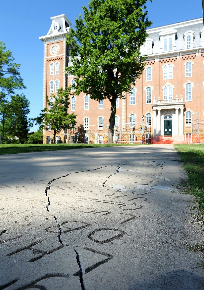 Cracks are visible in this section of the Senior Walk near Old Main on the University of Arkansas, Fayetteville, campus. 