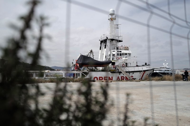 FILE - In this Wednesday April 17, 2019 file photo, The Proactiva's Open Arms rescue boat sits docked in Barcelona, Spain. A judge in Sicily has dropped an investigation against two member of the Spanish aid group Proactiva Open Arms deriving from a tense high-seas standoff last year when the crew refused to hand over 218 migrants rescued at sea to the Libyan coast guard. Proactiva welcomed the decision to drop the investigation into criminal association and aiding illegal migration Wednesday, calling it &#x2018;&#x2019;an additional step toward the truth.&#x2019;&#x2019; The group stated that it has always operated according to international roles. (AP Photo/Renata Brito)