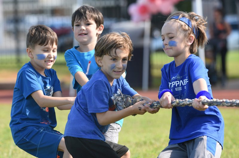 Tyler West (from left), Andy Potter, Charlie Jorgensen and Crew Breeden, all kindergartners at Vandergriff Elementary School, anchor the tug of war rope Monday during Field Day at the school in Fayetteville. The last day of classes at the school is Friday. NWA Democrat-Gazette/DAVID GOTTSCHALK