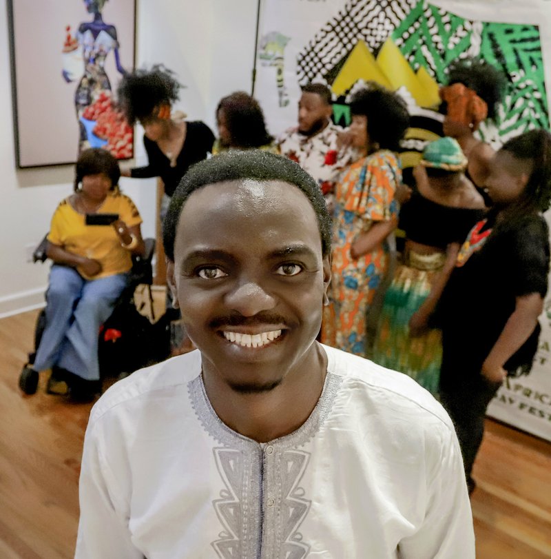 Benito Lubazibwa, organizer of Africa Day Fest, announced plans for this year’s event May 14 with help from some of the models who will participate in its fashion show. Photo by John Sykes Jr., Democrat-Gazette