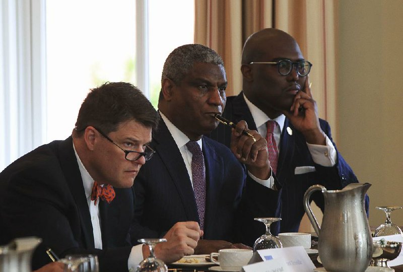 Grant Tennille (from left), former U.S. Secretary of Transportation Rodney Slater and Little Rock Mayor Frank Scott Jr. listen to the discussion Monday during an infrastructure roundtable that included mayors of city governments in Pulaski County and officials from various state and county agencies. 