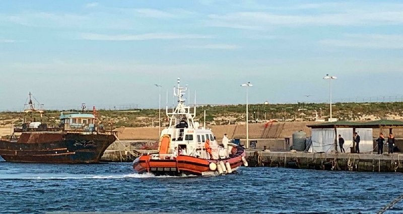 This photo taken on Friday and made available Monday shows the arrival of a Coast Guard boat carrying 18 migrants at the port of the Sicilian island of Lampedusa, southern Italy. 