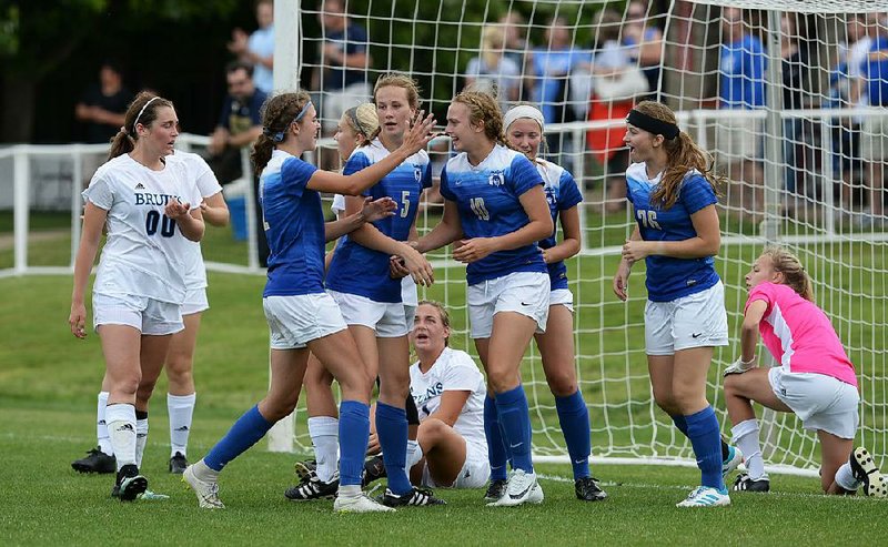 Harrison’s Sydney Shrum (center) is congratulated by her teammates after scoring her second goal Monday against Pulaski Academy in the Class 4A girls soccer state championship match at Razorback Field in Fayetteville. Shrum was named the most valuable player for the Lady Goblins, who won their seventh state title.