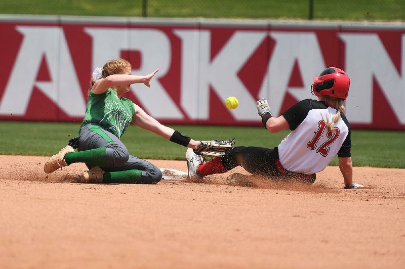 Rose Bud’s Joley Mitchell (17) slides into second base as Genoa Central’s Savanah Binkley loses control of the ball Monday during the Lady Ramblers’ 7-3 victory over the Lady Dragons in the Class 3A softball state championship game at Bogle Park in Fayetteville. Mitchell was 3 for 3, including a home run, with 4 runs scored and 3 RBI.
