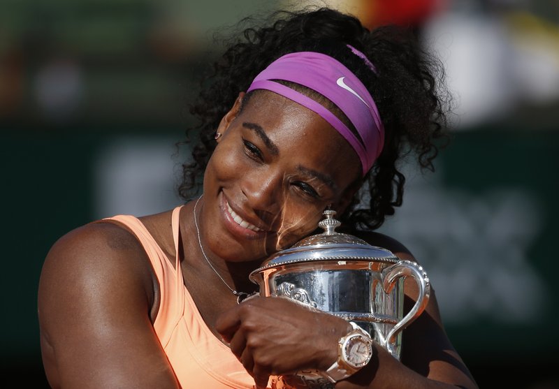 FILE - In this June 6, 2015, file photo, Serena Williams holds the trophy after winning the final of the French Open tennis tournament against Lucie Safarova of the Czech Republic, at the Roland Garros stadium in Paris, France. Welcome back to Paris, Serena Williams. The tennis world can&#x2019;t wait to find out exactly how that bothersome left knee is holding up. (AP Photo/Michel Euler, File)