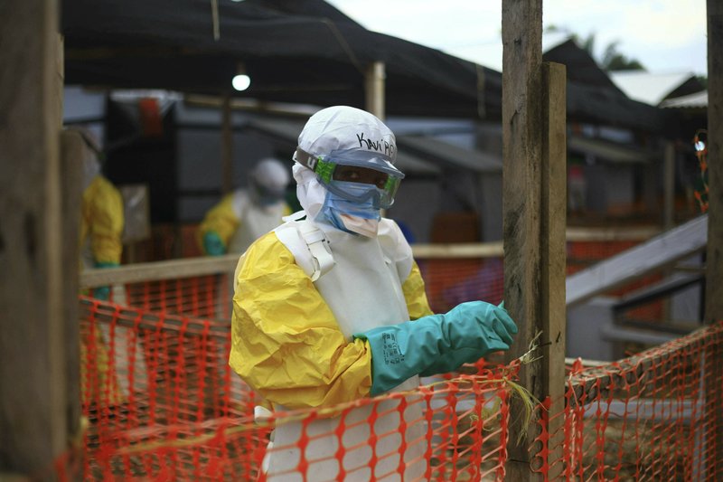 FILE - In this Tuesday April, 16, 2019 file photo, an Ebola health worker is seen at a treatment center in Beni, Eastern Congo. Internal documents by The Associated Press show the World Health Organization spent nearly $192 million on travel last year, with staffers sometimes breaking the rules by flying in business class, booking expensive last-minute tickets and traveling without the required approvals. (AP Photo/Al-hadji Kudra Maliro, file)