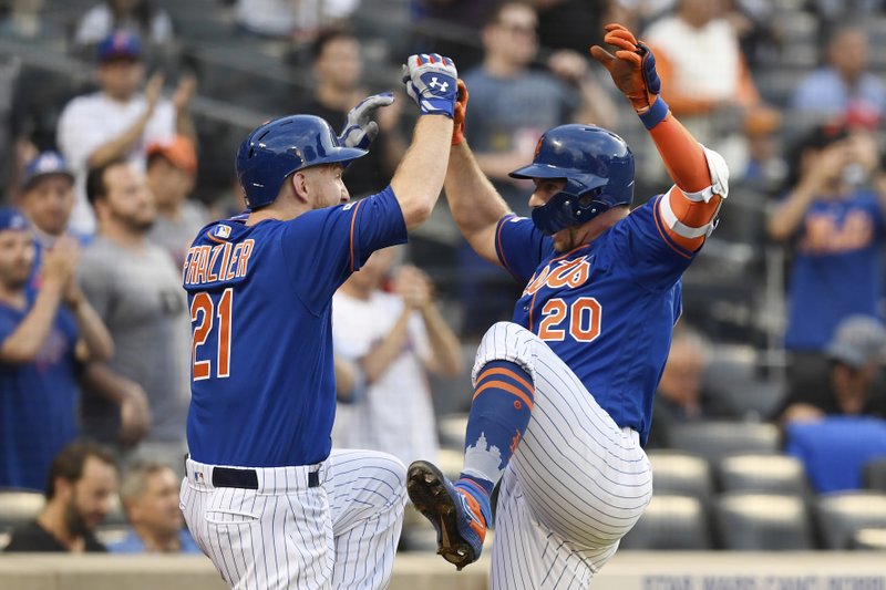 New York Mets' Pete Alonso (20) celebrates with Todd Frazier (21) after hitting a home run during the first inning of a baseball game against the Washington Nationals, Monday, May 20, 2019, in New York. (AP Photo/Sarah Stier)