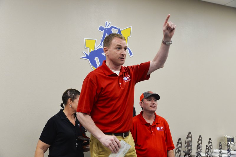 People’s Bank President Jamie Waller (center) thanks Kathy’s Dance Arts Studio members for their winning moves after the bank’s Home Town Grillers team took the 30th Magnolia Blossom Festival parade title on Saturday, May 18.
