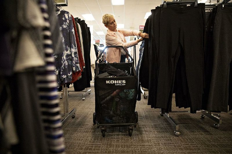 A shopper looks at clothing in May 2019 at a Kohl’s Corp. department store in Peru, Ill. 