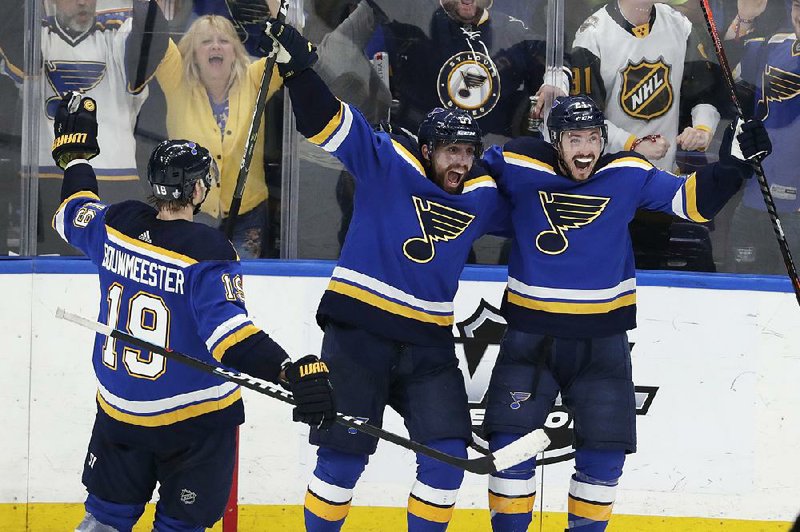 St. Louis Blues' Jay Bouwmeester (19), David Perron (57) and Tyler Bozak (21) celebrate after  Bozak’s goal in the third period of the Blues’ victory over the San Jose Sharks in Game 6 of their NHL playoff series Tuesday night. 