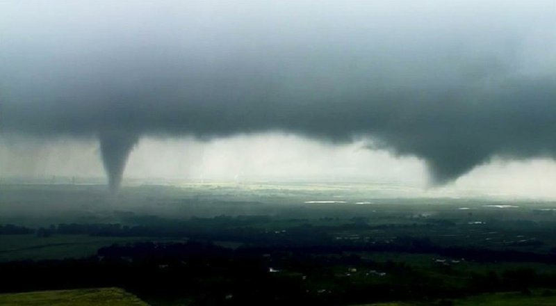 This image from video shows two funnel clouds formed over Crescent, Okla., on Monday. An intense storm system that weather forecasters labeled “particularly dangerous” swept through the Southern Plains on Monday, spawning a few tornadoes that caused some damage and a deluge of rain but no reports of injuries. 