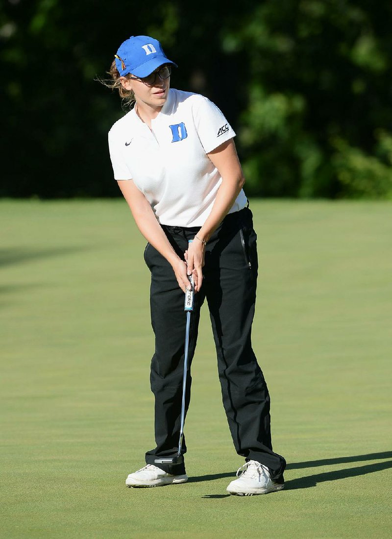 Duke’s Virginia Elena Carta lines up her putt Tuesday on the 14th green during her match with Ziyi Wang of Stanford. Carta won the match in 24 holes as Duke went on to defeat Stanford 3-2. 