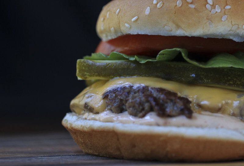 Griddled Smashed Burger with American cheese is topped with pickle, lettuce and tomato on a sesame seed bun slathered with Chipotle Mayo.
Photo by Staton Breidenthal 