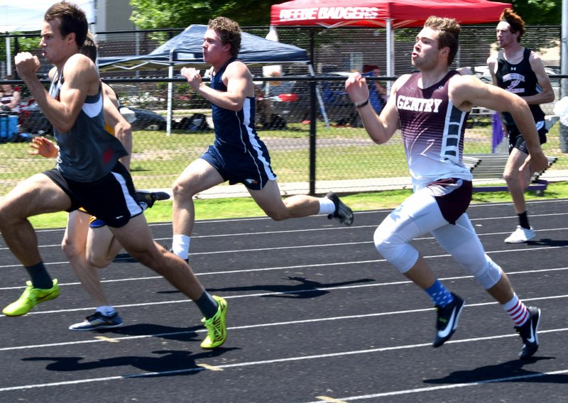 Westside Eagle Observer/MIKE ECKELS Brandon Atwood (right) gives his all as he nears the finish line in the 100-meter dash during the Arkansas Decathlon track meet in Fayetteville May 15. Atwood, running for Gentry, finished with a time of 11.61 for 24th place out of 71 competitors.