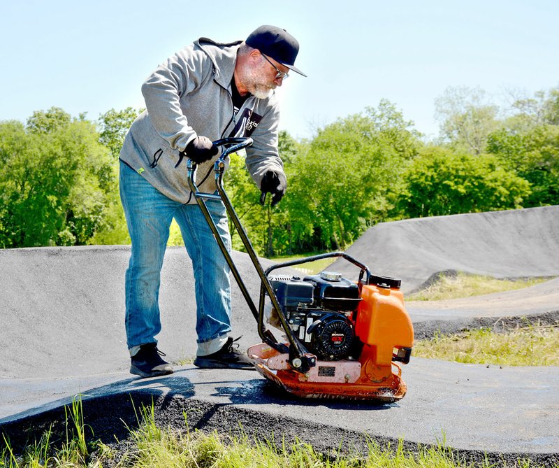 Janelle Jessen/Herald-Leader Tom Ritz of PumpTrax USA, the Ohio-based company he co-owns with Jason Schiefelbein, was in Siloam Springs to build the pump track at City Lake last week. Ritz is a world-renowned BMX track designer who built BMX tracks for the 2008, 2012 and 2016 Olympic Games.