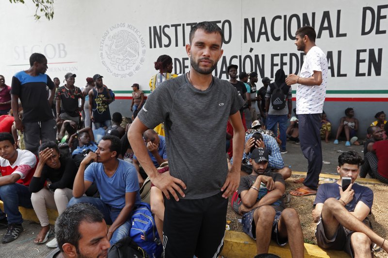  In this April 29, 2019 file photo, Rahjit, from India, poses for a photo as he waits with other migrants for a ticket to register their entry into Mexico at an immigration station in Tapachula, Chiapas state, Mexico. The National Immigration Institute said on Monday, May 20, 2019, it is studying a change in the way it handles the migrants who have been overwhelming its facilities near the border with Guatemala. (AP Photo/Moises Castillo, File)