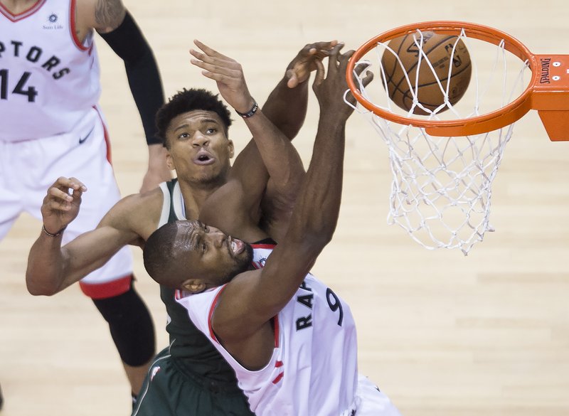 Toronto Raptors center Serge Ibaka battles for the ball against Milwaukee Bucks forward Giannis Antetokounmpo during the second half of Game 4 of the NBA basketball playoffs Eastern Conference finals, Tuesday, May 21, 2019, in Toronto. (Nathan Denette/The Canadian Press via AP)