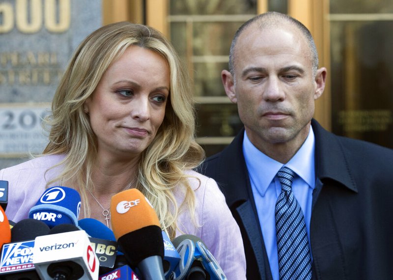 In this April 16, 2018 file photo, adult film actress Stormy Daniels, left, stands with her lawyer Michael Avenatti as she speaks outside federal court, in New York. Avenatti, the attorney who rocketed to fame through his representation of Daniels in her battles with President Donald Trump, was charged Wednesday, May 22, 2019, with ripping her off. Federal prosecutors in New York City say Avenatti used a doctored document to divert about $300,000 that Daniels was supposed to get from a book deal, then used the money for personal and business expenses. (AP Photo/Mary Altaffer, File)