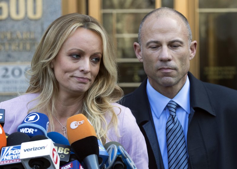 FILE - In this April 16, 2018 file photo, adult film actress Stormy Daniels, left, stands with her lawyer Michael Avenatti as she speaks outside federal court, in New York. Avenatti, the attorney who rocketed to fame through his representation of Daniels in her battles with President Donald Trump, was charged Wednesday, May 22, 2019, with ripping her off. Federal prosecutors in New York City say Avenatti used a doctored document to divert about $300,000 that Daniels was supposed to get from a book deal, then used the money for personal and business expenses. (AP Photo/Mary Altaffer, File)

