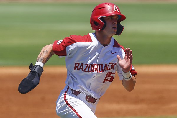 Arkansas' Casey Martin runs home to score on a RBI single from Arkansas' Dominic Fletcher during the first inning of a Southeastern Conference tournament game against Ole Miss, Wednesday, May 22, 2019, in Hoover, Ala. (AP Photo/Butch Dill)