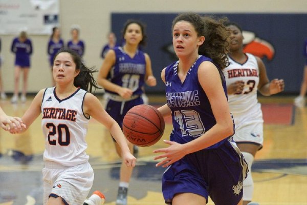 Sasha Goforth (13) of Fayetteville drives to the basket ahead of Skylar Brooks (20) of Rogers Heritage Tuesday, Jan. 30, 2018, during the first half in War Eagle Arena in Rogers. Visit nwadg.com/photos to see more photographs from the game.