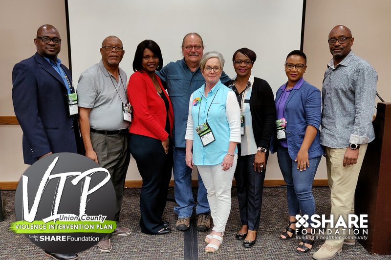 SHARE: (Center) Debbie Watts, vice president of community impact for the SHARE Foundation, and Robert Holt, director of Healing Waters Outreach, pose with members of a delegation from the Bahamas at the annual Neighborhoods, USA conference in Palm Springs, California last week.