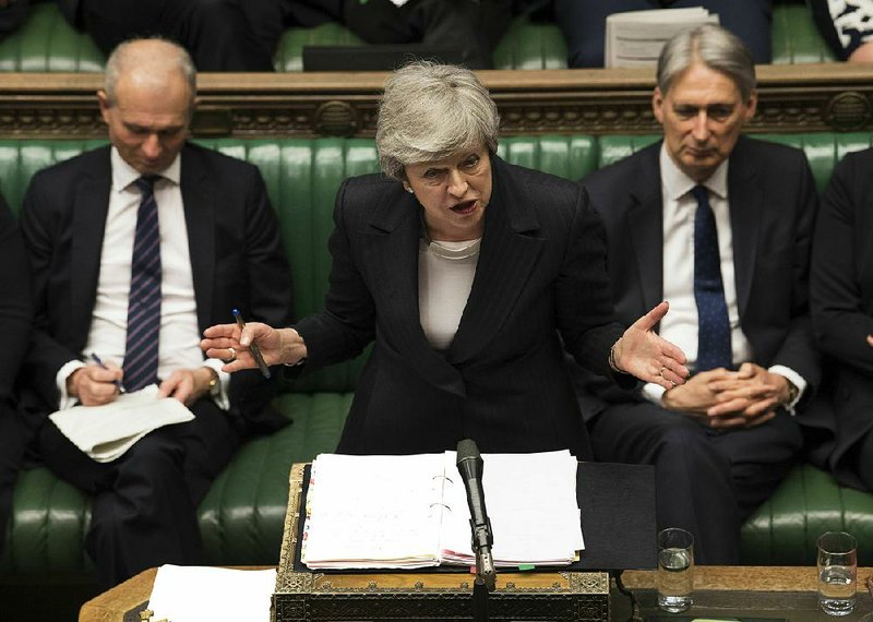 British Prime Minister Theresa May answers a question Wednesday during her weekly session in the House of Commons in London. 