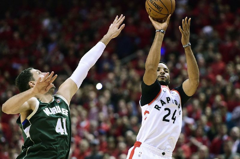 Toronto’s Norman Powell (right) scored 18 points from off the bench in the Raptors’ 120-102 victory over Milwaukee on Tuesday night. 