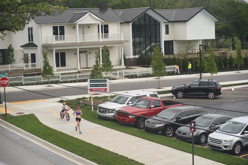 NWA Democrat-Gazette/FLIP PUTTHOFF Workers put the finishing landscaping touches Wednesday on a remodeled home on Northeast Blake Street in Bentonville. Bentonville's population increased from 49,341 in 2017 to 51,111, according to Census estimates, growing by 3.6%.