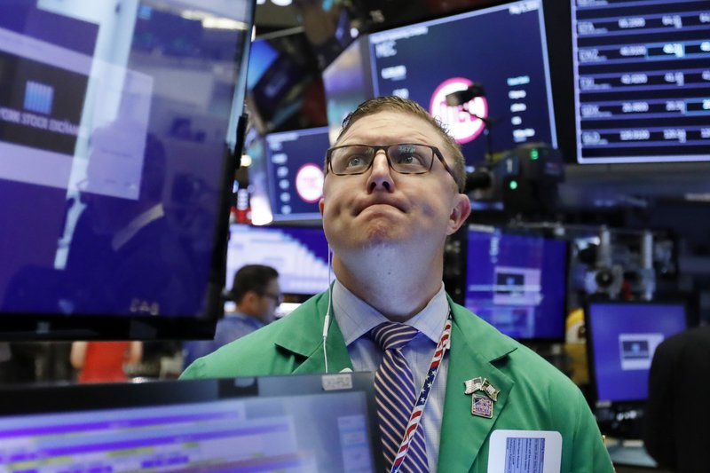 In this May 9, 2019, file photo trader Ryan Falvey works on the floor of the New York Stock Exchange. Banks and retailers pushed the market broadly lower in morning trading on Wall Street Wednesday, May 22. (AP Photo/Richard Drew, File)