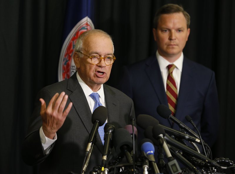 McGuire Woods law firm partner, Richard Cullen, left, gestures as Ben Hatch, right, listen during a news conference on a report announcing the results of an investigation into a blackface photo that appeared on the yearbook page of Virginia Gov. Ralph Northam from his Eastern Virginia Medical School yearbook in Norfolk, Va., Wednesday, May 22, 2019. An investigation ordered up by Eastern Virginia Medical School failed to determine whether Gov. Ralph Northam is in a 1984 yearbook photo of a man in blackface next to someone in a Ku Klux Klan hood. (AP Photo/Steve Helber)