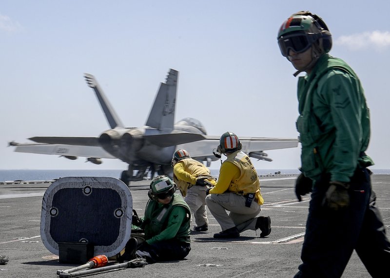 In this Monday, May 20, 2019 photo, released by U.S. Navy, an F/A-18E Super Hornet from the "Jolly Rogers" of Strike Fighter Squadron (VFA) 103 launches from the flight deck of the Nimitz-class aircraft carrier USS Abraham Lincoln (CVN 72) on Arabian Sea. (Mass Communication Specialist 3rd Class Jeff Sherman/U.S. Navy via AP)