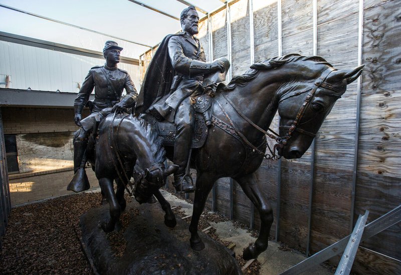 In this Dec. 20, 2018, file photo the 1935 statue of Robert E. Lee, right, and a young soldier by sculptor Alexander Phimister, sit in storage at Hensley Field, the former Naval Air Station on the west side of Mountain Creek Lake in Dallas. Dallas City Council on Wednesday, May 22, 2019 declared the statue surplus property and offered to sell it for a minimum $450,000, what it cost to move the bronze artwork from public view. The statue was removed from a park in September 2017 and put in storage and has been appraised at $950,000, which Dallas authorities say could pay for removal of the city's Confederate War Memorial. (Ashley Landis/The Dallas Morning News via AP, File)/The Dallas Morning News via AP)