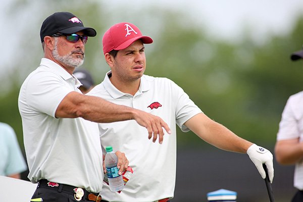 Arkansas golfer Julian Perico (right) talks with Razorbacks head coach Brad McMakin during a practice round for the NCAA Men's Golf Championships at Blessings Golf Club on Thursday, May 23, 2019, in Fayetteville.