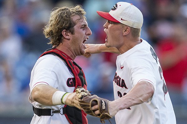 Georgia pitcher Aaron Schunk (right) and catcher Mason Meadows celebrate following a 3-1 victory over Arkansas during an SEC Tournament game Thursday, May 23, 2019, in Hoover, Ala. 