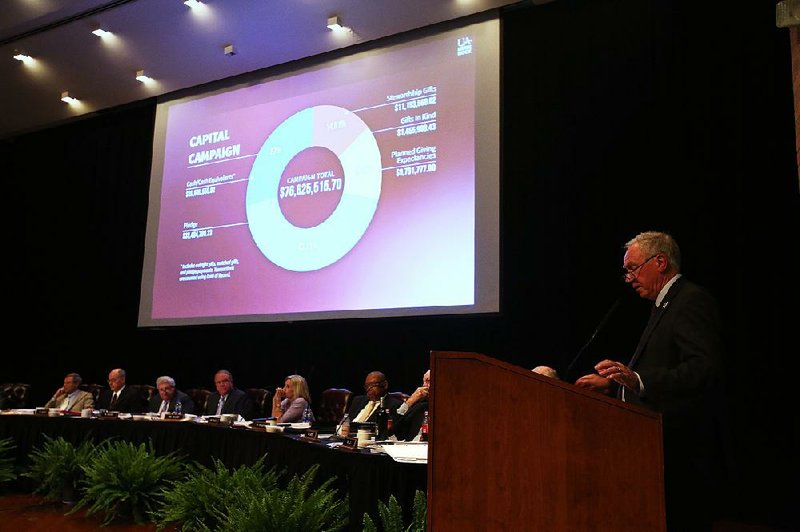 Andrew Rogerson (right), University of Arkansas at Little Rock chancellor, gives a presentation Thursday during the UA board of trustees meeting at UALR. Rogerson thanked the trustees for their patience as his university deals with deficit and enrollment problems. 